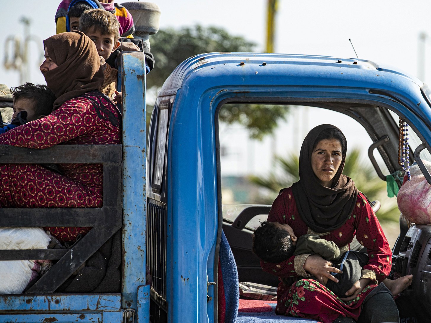 Syrian Woman in a truck with a baby